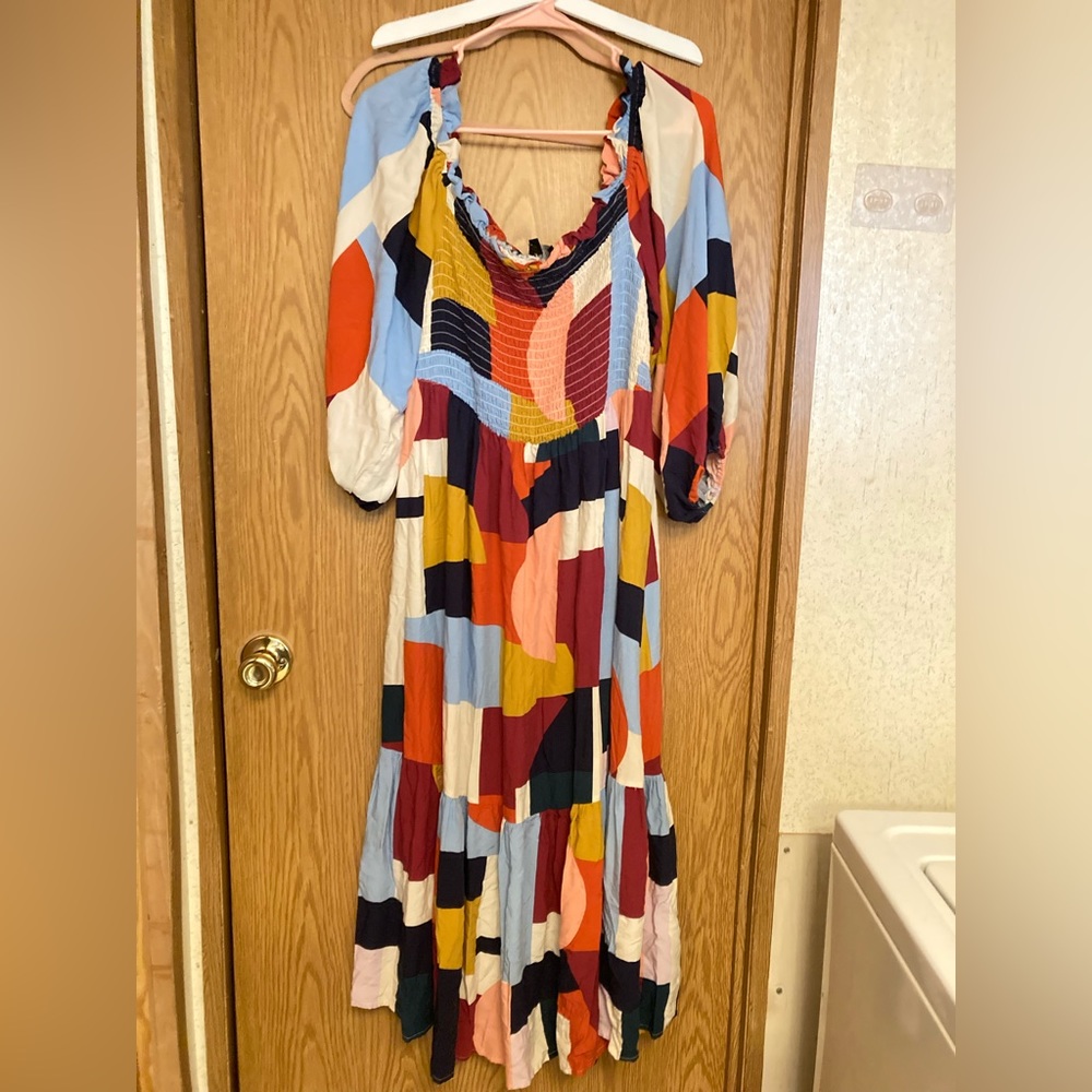 Long colorful dress, comfy, loose and reaches knees depending on height.